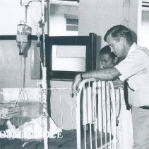 Thomas Bowles with patient while the SS HOPE was in Ceylon.