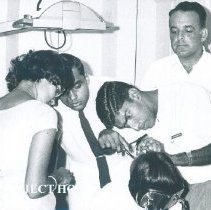 James Peltier with counterpart and patient on the SS HOPE in Ceylon.