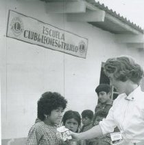 HOPE nurse distributes milk during the 1962 mission of the SS HOPE Peru.
