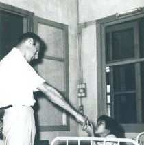 An unknown HOPE doctor with a patient on the SS HOPE in Saigon, Viet Nam.