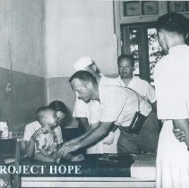 An unknown HOPE doctor with counterparts on the SS HOPE in Saigon, Viet Nam
