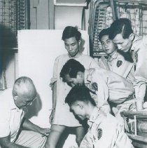 An unknown HOPE doctor with counterparts on the SS HOPE in Saigon, Viet Nam