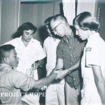 Unknown nurse and doctor with patient on the SS HOPE on Voyage I 1960.