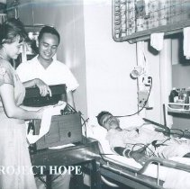 Harriet Seipel doing electrocardiograph on SS HOPE in Indonesia 1960.