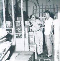 Chief storekeeper with counterpart on SS HOPE in Indonesia.