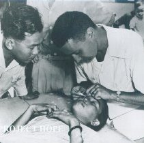 Unknown HOPE doctor on left with counterpart and patient on SS HOPE 1960.