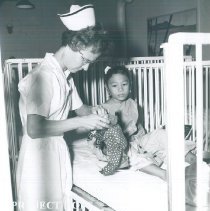 Mary Finley with patient on the SS HOPE in Indonesia 1960