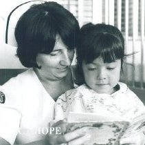 HOPE nurse Mary Payne reading to young patient in Mercy Hospital.