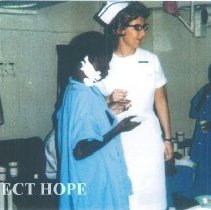 Sharon Rutz with patient on the SS HOPE in Guinea 1964.