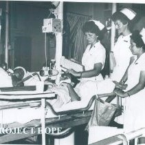 Unknown HOPE nurses check patient with counterpart on the SS HOPE in Quayaq