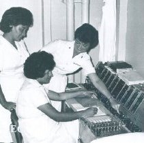 Unknown HOPE staff instructing on a Cardiography machine on the SS HOPE in