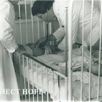 Dr Terry King with 2 Polish patients in the same bed in Poland.