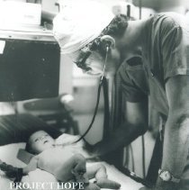 Dr James Graham examines patient in Institute of Pediatrics Poland.