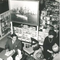 William B Walsh discussing his book with the buyer before signing it