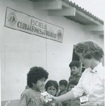 HOPE nurse unknown handing out milk at a clinic in Peru in 1962.