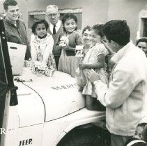 John Adam and HOPE staff giving milk to chilcrend in Peru on SSHOPE 1962.