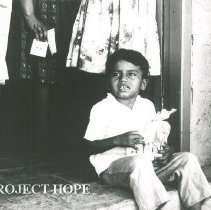 Peruvian chile with carton of milk from the SSHOPE in Peru in 1962.