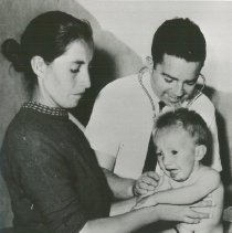 Archie Golden examines a Peruvian child on SSHOPE in Peru in 1962.