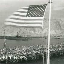 SSHOPE departure with American flag in foreground in Peru in 1962.