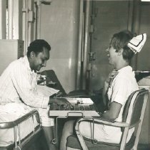 HOPE nurse unknown playing game with a patient on SS HOPE in Colombia.