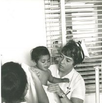 Project HOPE nurse, Mo Gallagher, with patient in Laredo, TX in 1969.
