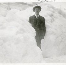 John Linder standing next to snowbank, Blizzard of 1913