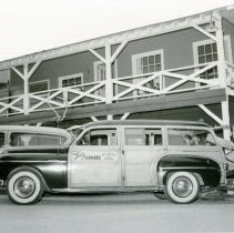 Bill Harmsen loading a car with "Jolly Rancher Ice Cream and Candy" sign