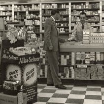 Jack McDermott behind counter at Foss Drug Store