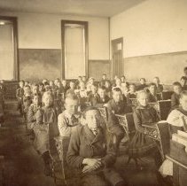 Grace Rowe and South School students seated in classroom c. 1910