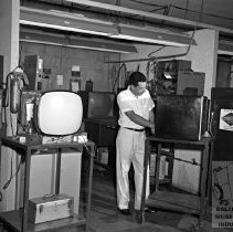 Worker repairing T.V.s