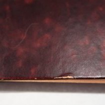 Back cover lower edge abrading and scratch