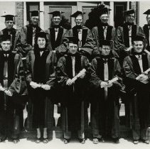 Twelve members of the KCOS Class of 1948 Jan in caps and gowns