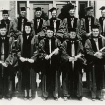 Twelve members of the KCOS Class of 1948 Jun in caps and gowns