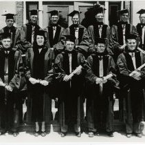 Twelve members of the KCOS Class of 1948 Jun in caps and gowns
