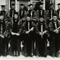 Twelve members of the KCOS Class of 1948 Jun in caps and gowns