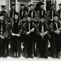 Twelve members of the KCOS Class of 1948 Jun in caps and gowns