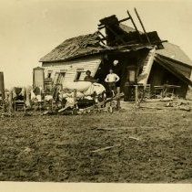 Men standing with furniture in front of demolished house 1899 Apr