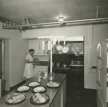 Lena Hatcher in apron in kitchen