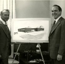 Edward Borman with unidentified man in front of architect plan