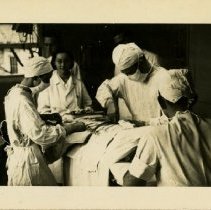 Earl Laughlin operating with doctors and scrub nurse 1938 Feb 10