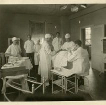 George M. Laughlin operating on patient with attendants in hospital
