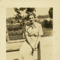 Woman sitting on fence ca. 1942