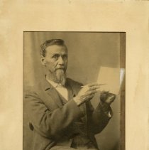 AT Still holding book and pointing with pencil