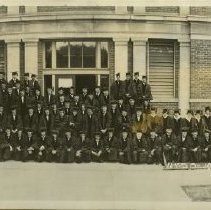 KCOS students in caps & gowns in front of building 1928 Jun