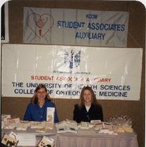 Melissa Fabian and Stephanie Jones in Front of Banner