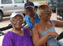 Mamie Norville Seated with Two Unknown Women, One Wearing Blue Baseball Hat