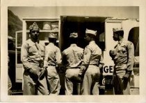 Five Men Standing in front of an Open Vehicle