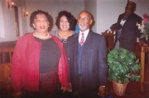 Marian Coleman Standing Behind Unknown Woman and Man in Church Interior