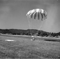 Man landing in parachute near Roseburg, ca 1950