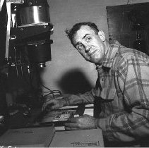 Dick Gilman, Sr. in darkroom, ca 1950